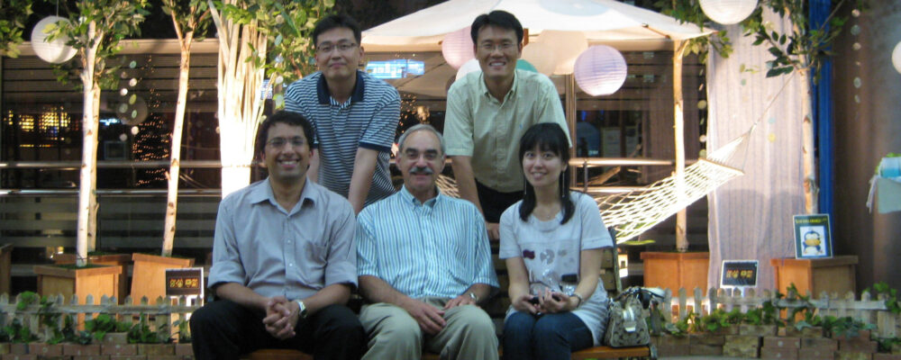 A group of five people posing for a photo
